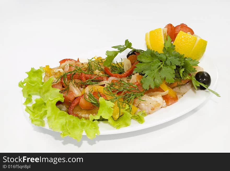 Salad on white plate from many ingredients, isolated