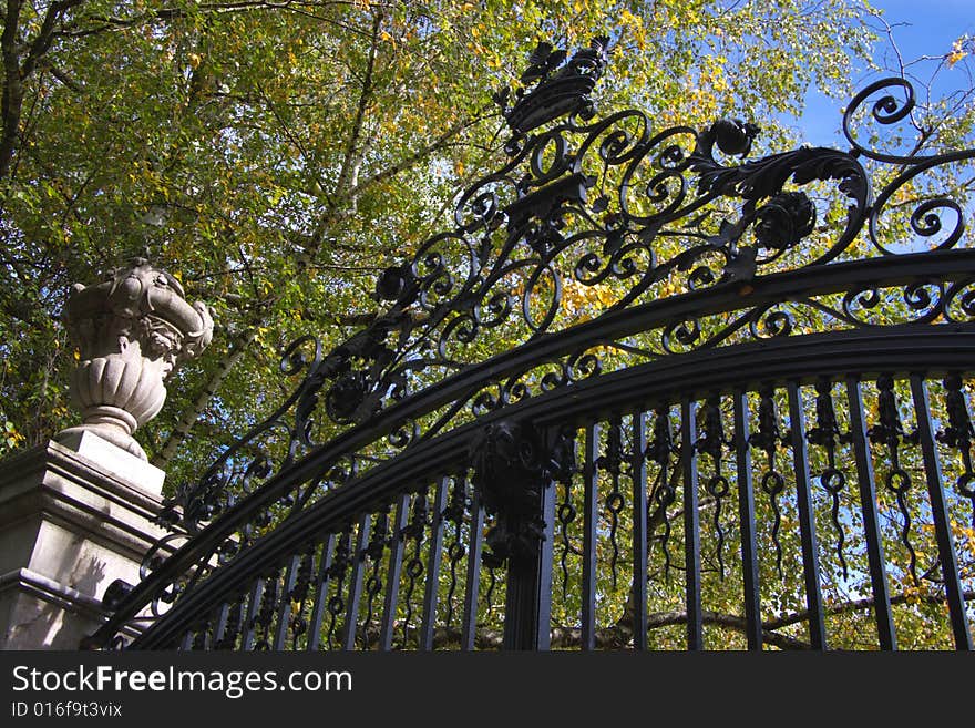 Bronze decorated fence in a park, horizontal. Bronze decorated fence in a park, horizontal.