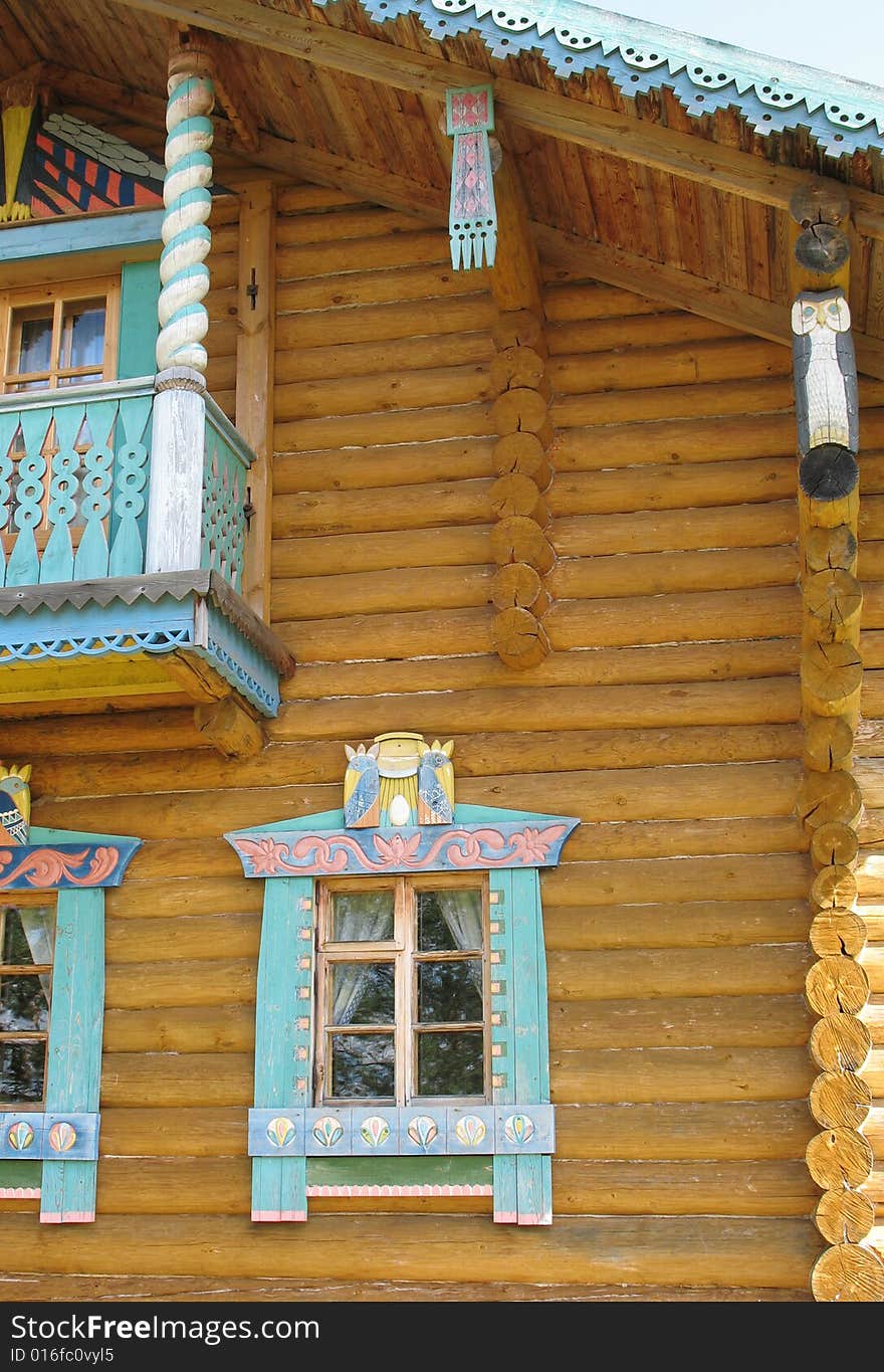 Russian style. Wooden blockhouse on the blue sky background. Russian style. Wooden blockhouse on the blue sky background.