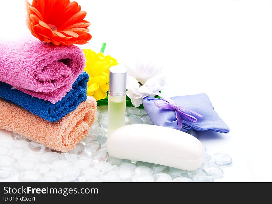 Colorful bath towels with flowers, soap and perfume. Colorful bath towels with flowers, soap and perfume