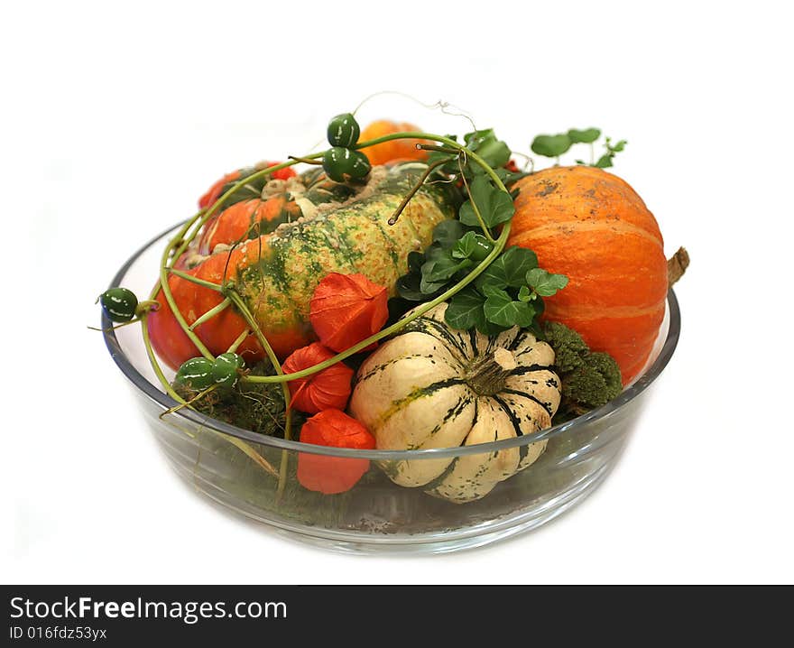 Isolated pumpkins composition in glass vase. Isolated pumpkins composition in glass vase