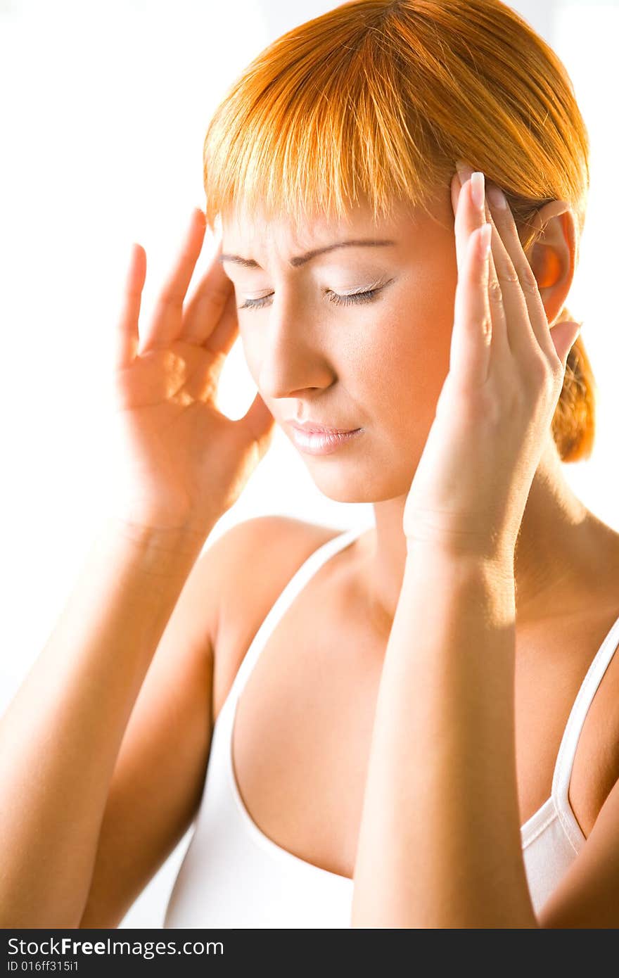 Red-haired young woman with headache. Focused on face. Red-haired young woman with headache. Focused on face.