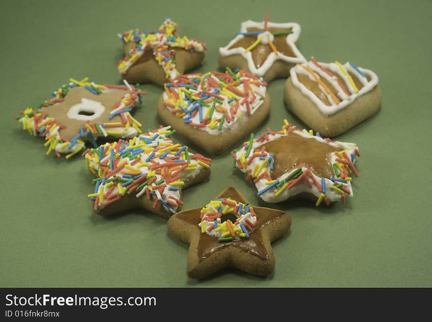 Decorated gingerbread cookies on green paper. Decorated gingerbread cookies on green paper