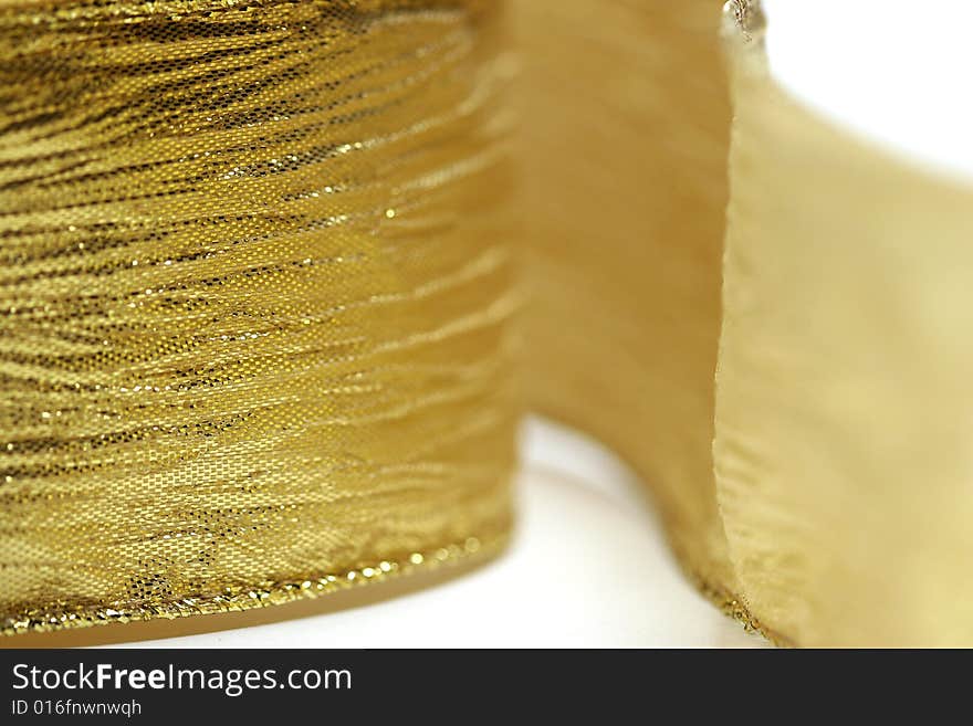 Close up of gold ribbon on white background