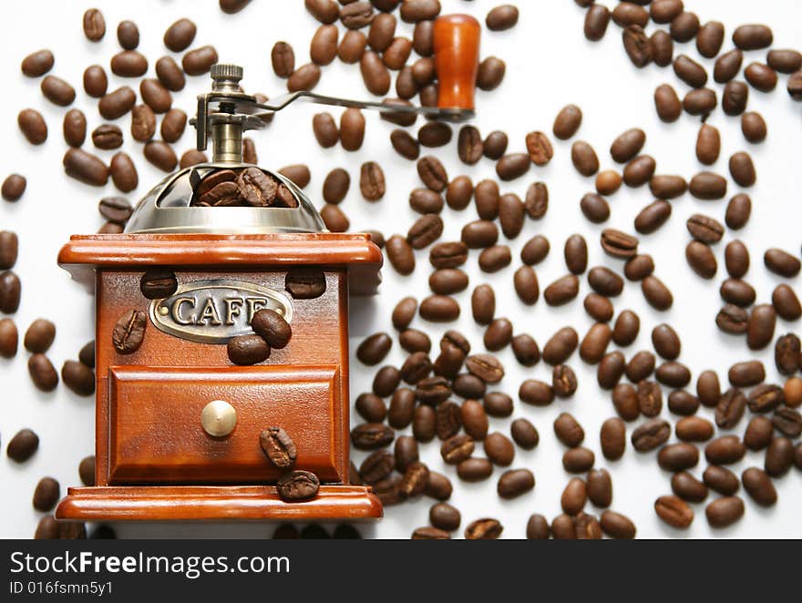 Old-fashioned coffee grinder with coffee beans