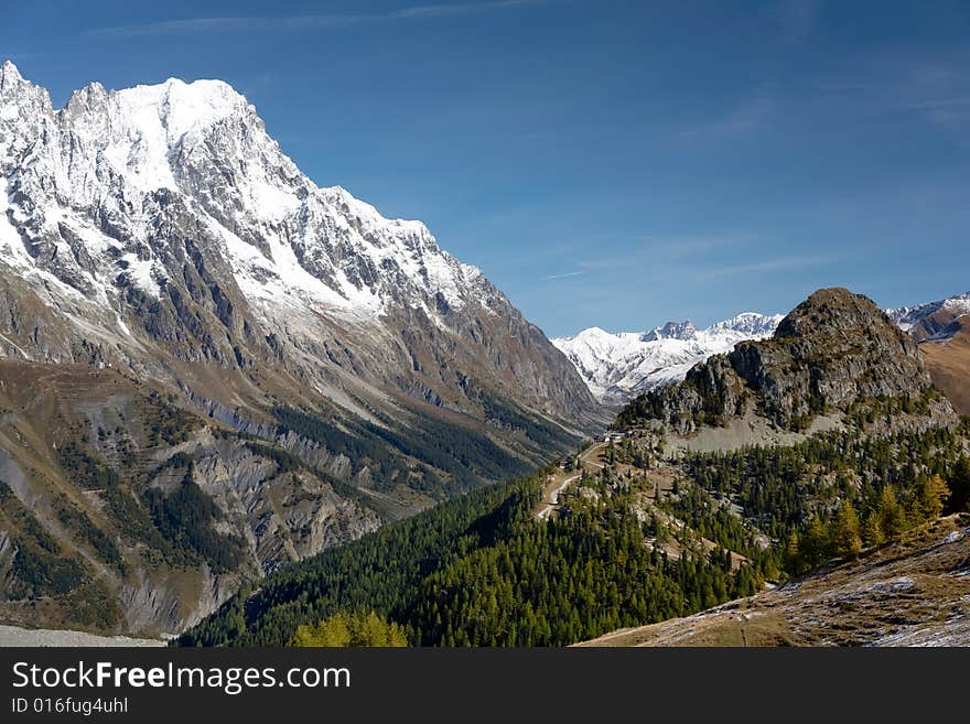 Summer view of snowcapped peaks in an alpine valley. Gran Jourasses (Mont Blanc massif), Val Veny, Courmayeur, Italy. Summer view of snowcapped peaks in an alpine valley. Gran Jourasses (Mont Blanc massif), Val Veny, Courmayeur, Italy.