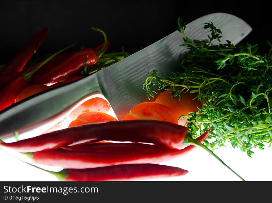 Arrangement of herbs, chillies and kitchen knife. Arrangement of herbs, chillies and kitchen knife