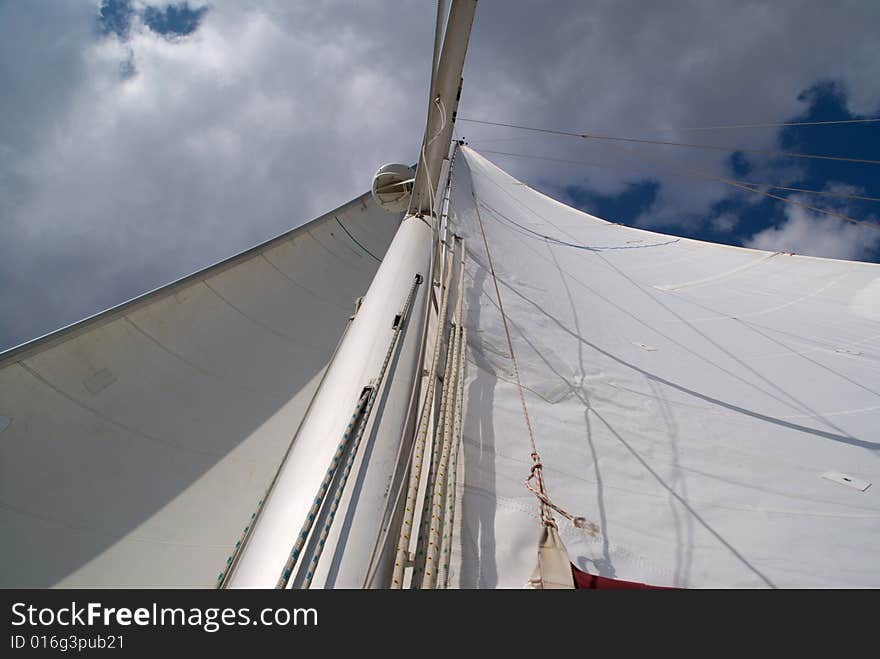 Looking up at sails and mast of boat.