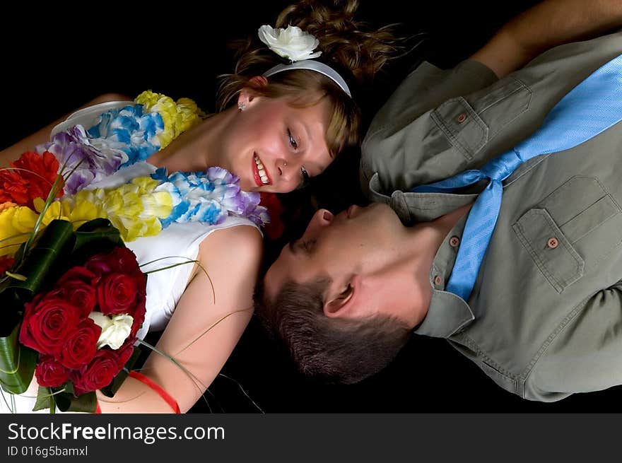 Young happy laughing wedding couple on black background, studio shot. Young happy laughing wedding couple on black background, studio shot