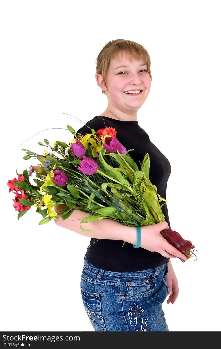 Happy smiling young girl presenting flowers, white background, studio shot