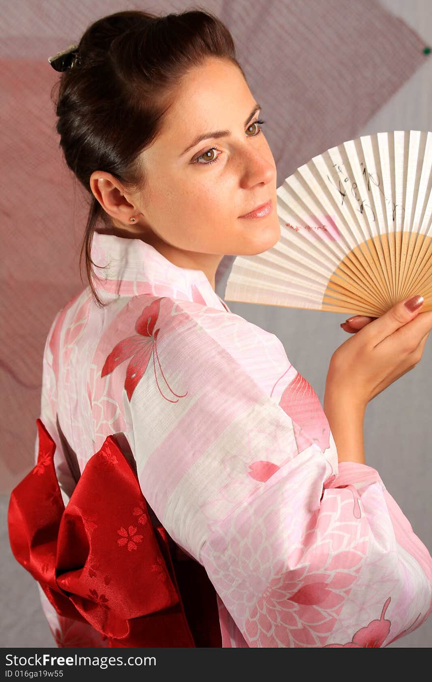 A photograph of a young girl wearing pink yukata. A photograph of a young girl wearing pink yukata.