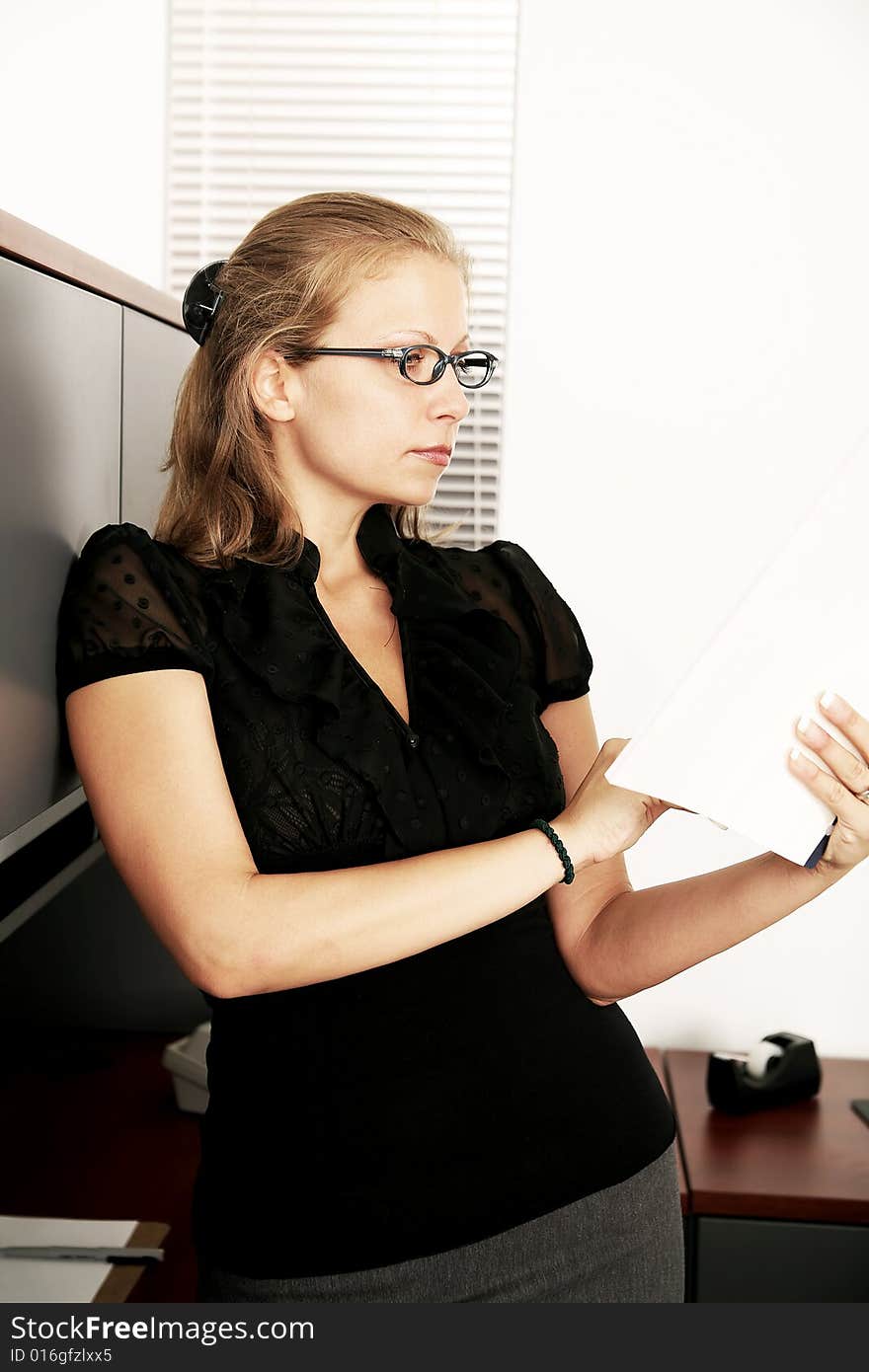 Beautiful caucasian secretary working in her office. Beautiful caucasian secretary working in her office