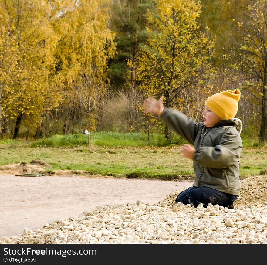 Little boy threw stones in the park. Little boy threw stones in the park