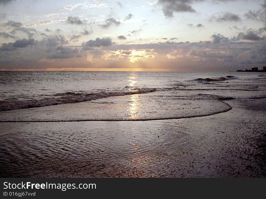 A fantastic sunset reflection off the ocean waves on Madeira Beach, Florida. A fantastic sunset reflection off the ocean waves on Madeira Beach, Florida.