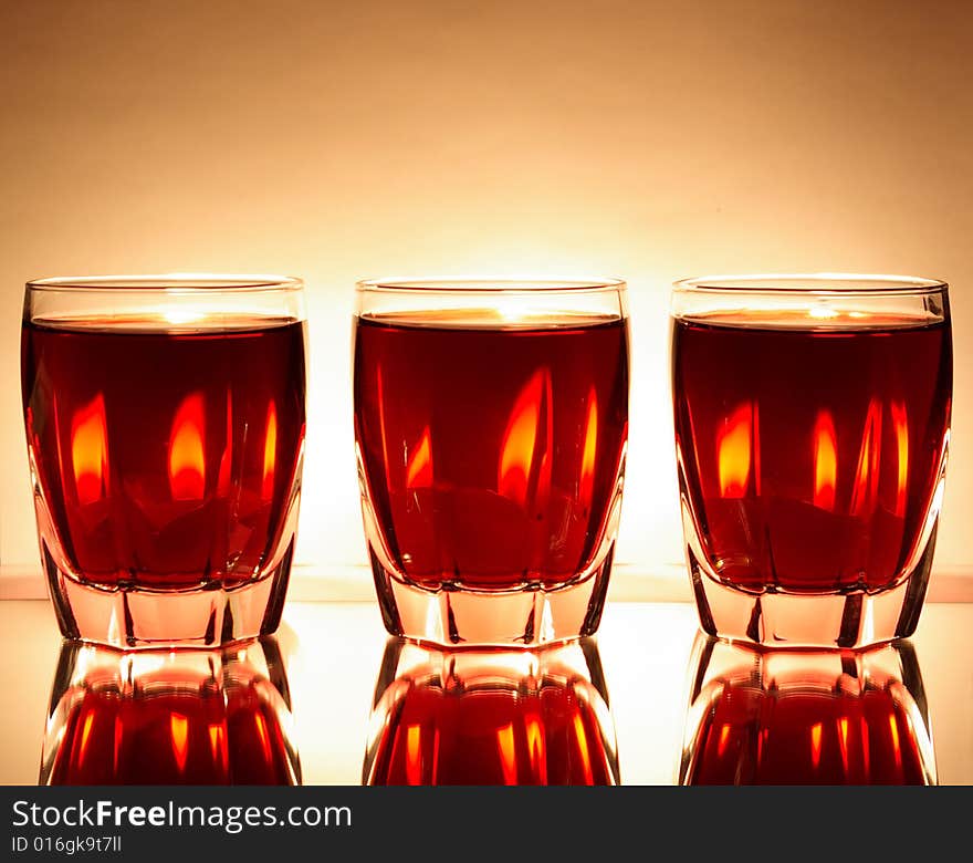 Glasses with red wine and candles