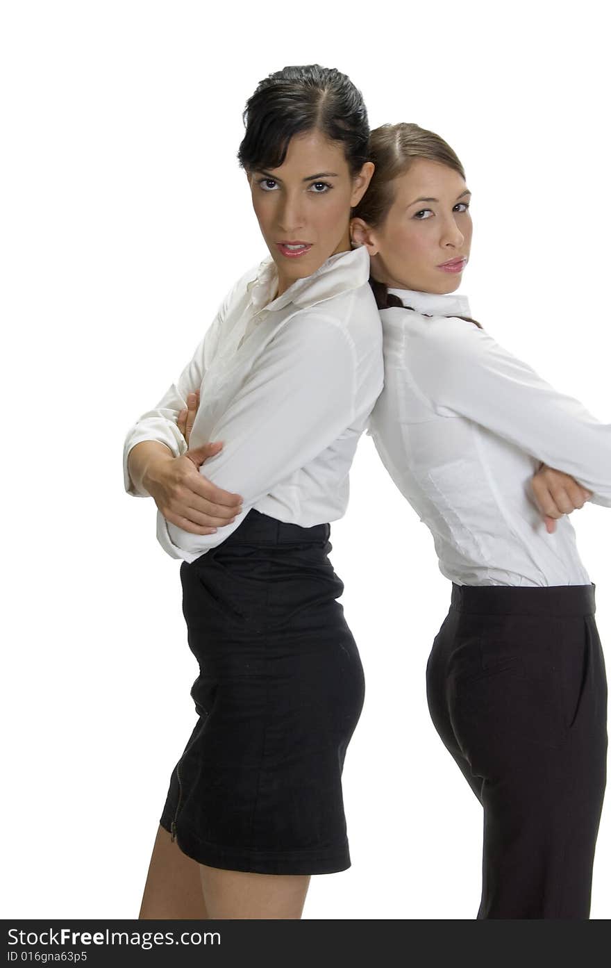 Young women standing back to back with white background