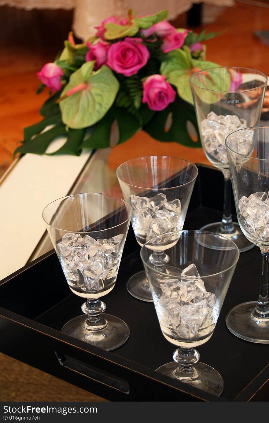 Five glasses with ice and a nice bunch of pink roses. Five glasses with ice and a nice bunch of pink roses