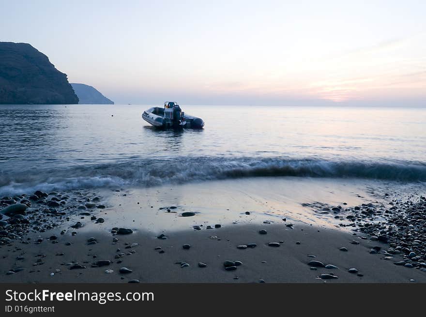 Lonely boat in a bay by the sunrise. Lonely boat in a bay by the sunrise