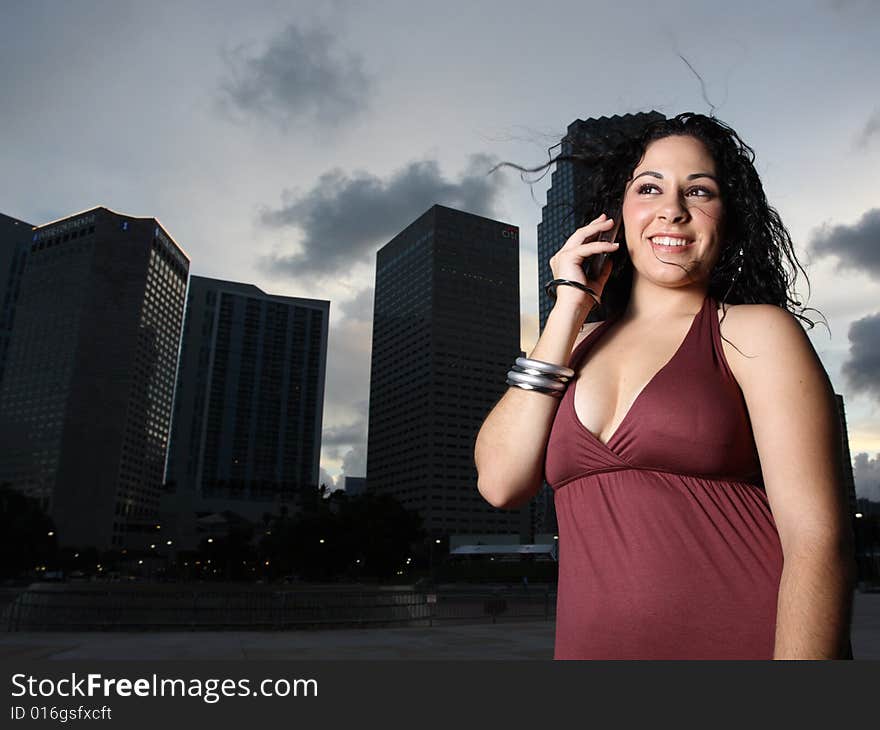 Young woman smiling and talking on a cell phone. Young woman smiling and talking on a cell phone.