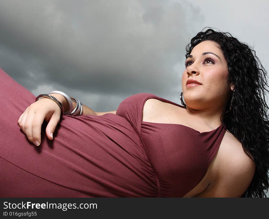 Woman posing with storm clouds in the background