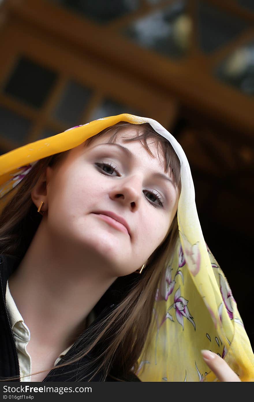 Portrait of brunette girl in yellow kerchief