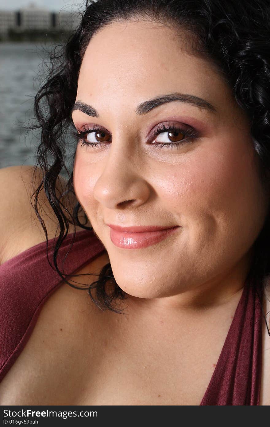 Headshot of a beautiful young woman smiling.