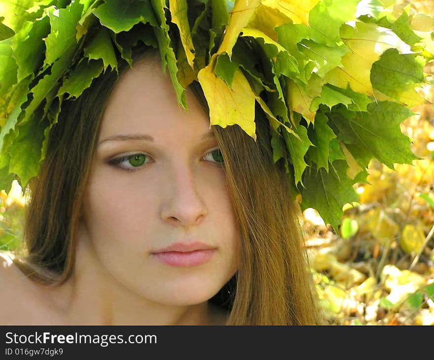 Nice young girl with autumn maple wreath. Nice young girl with autumn maple wreath