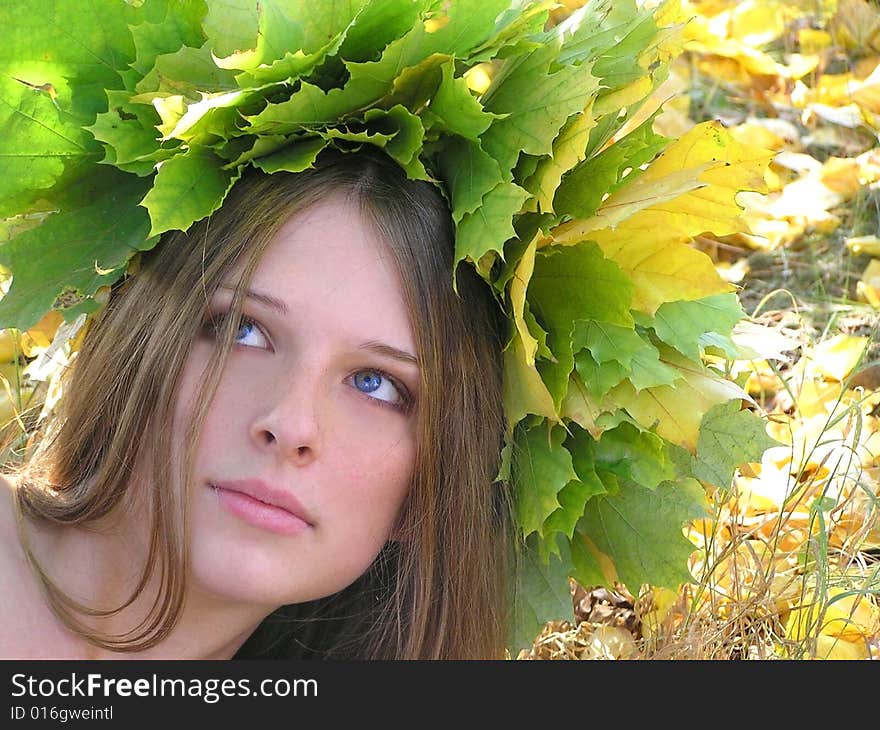 Nice young girl with autumn maple wreath. Nice young girl with autumn maple wreath