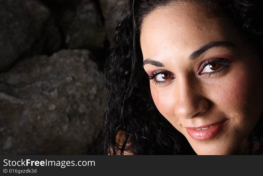 Closeup headshot of a young female smiling at the camera.