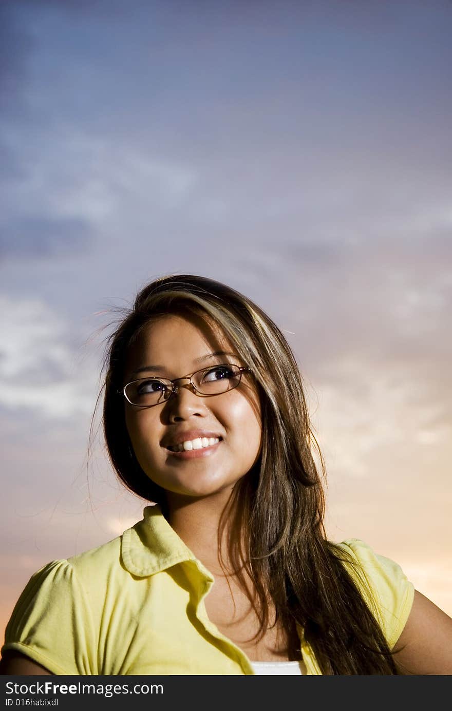 Female outside enjoying sunset with a smile. Female outside enjoying sunset with a smile