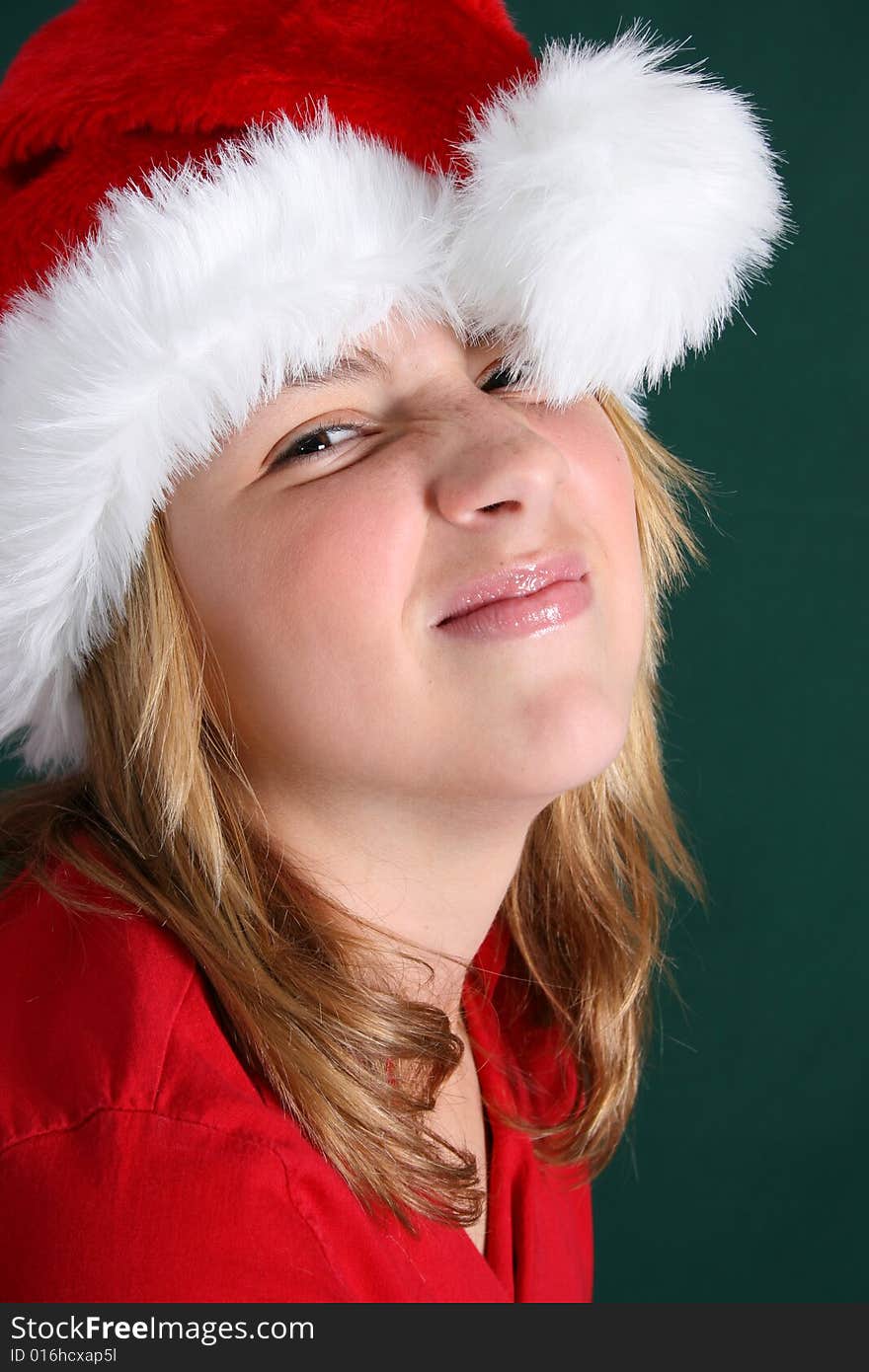 Beautiful teenager wearing a red shirt and christmas hat. Beautiful teenager wearing a red shirt and christmas hat