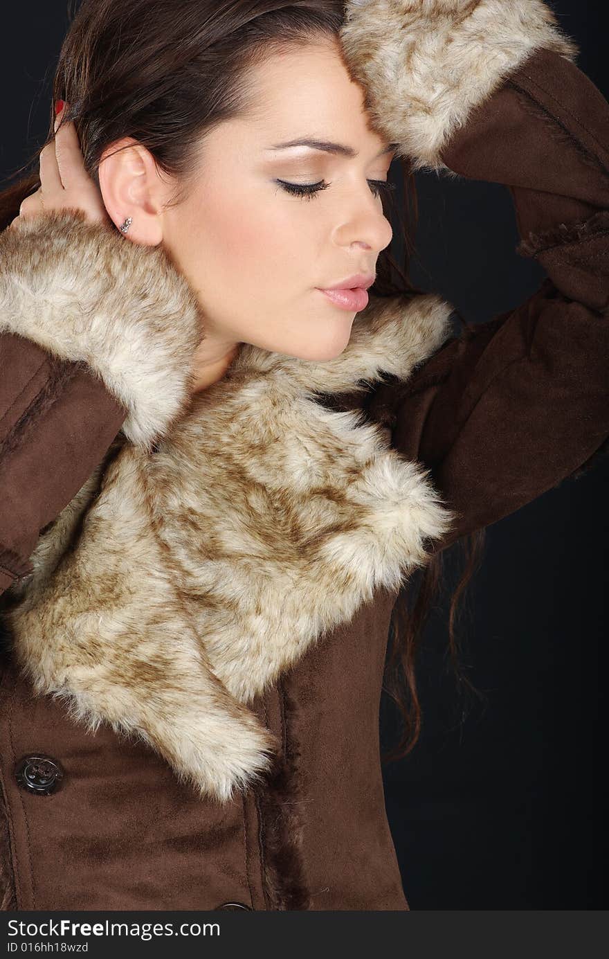 Portrait of a winter woman wearing brown fur