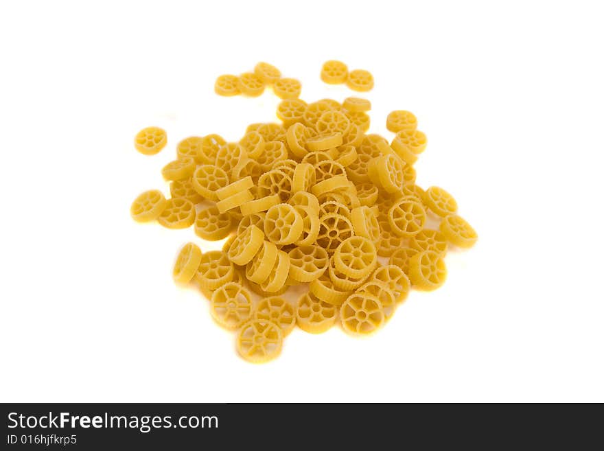 Raw wheels macaroni isolated on a white background. Raw wheels macaroni isolated on a white background