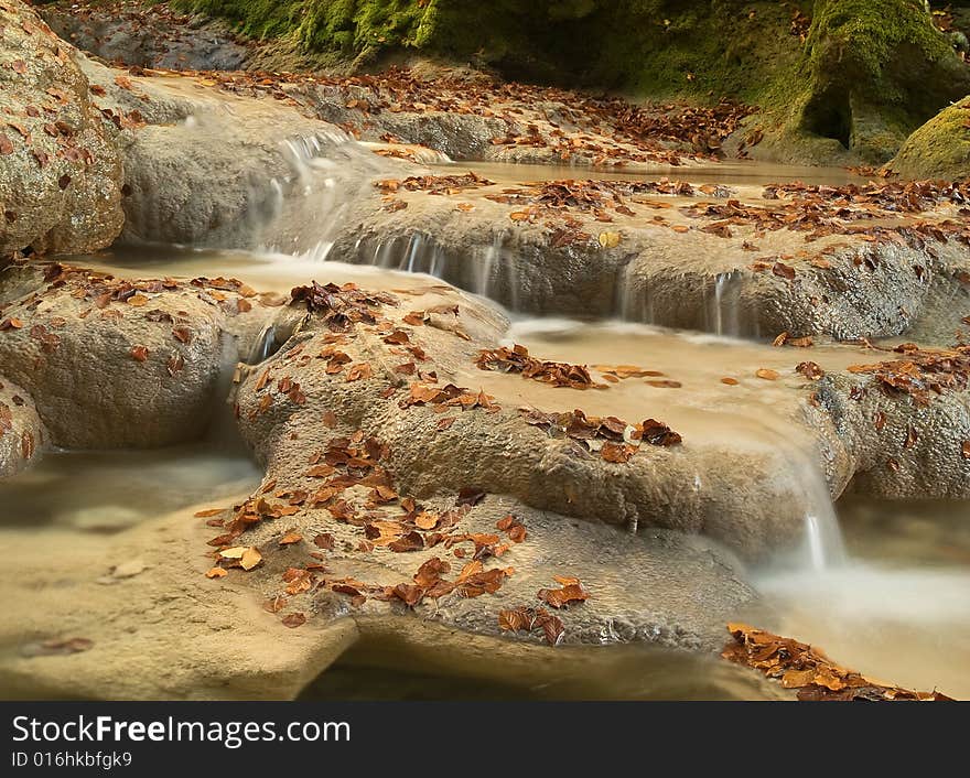 Autumn scenic water stream in the forest. Autumn scenic water stream in the forest