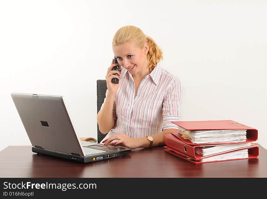 Young woman at the office, working on her laptop. Young woman at the office, working on her laptop.