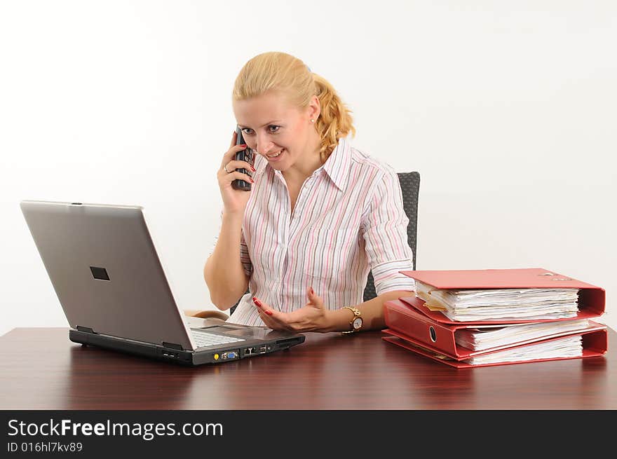 Young woman at the office, working on her laptop. Young woman at the office, working on her laptop.