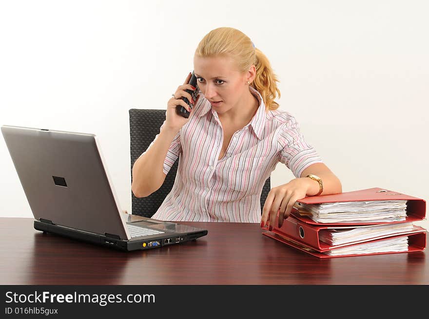 Young woman at the office, working on her laptop. Young woman at the office, working on her laptop.