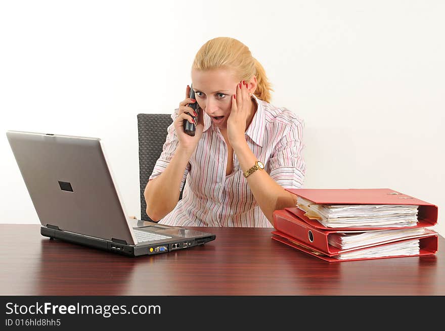 Young woman at the office, working on her laptop. Young woman at the office, working on her laptop.