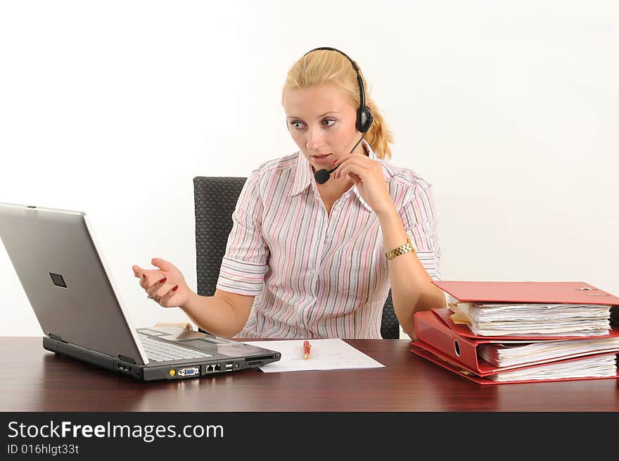 Young woman at the office, working on her laptop. Young woman at the office, working on her laptop.