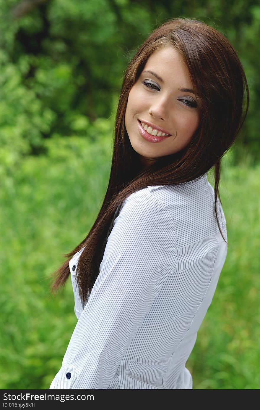 Woman wearing white sweater relaxing outdoor. Woman wearing white sweater relaxing outdoor