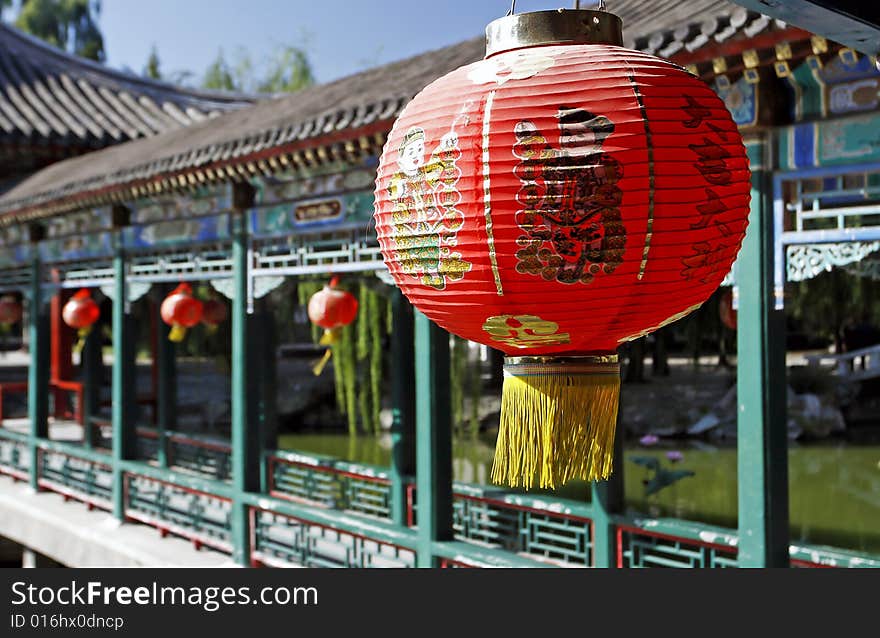 Red lantern on the ancient garden long corridor of China. Chinese on the lantern is that a good luck is lucky.