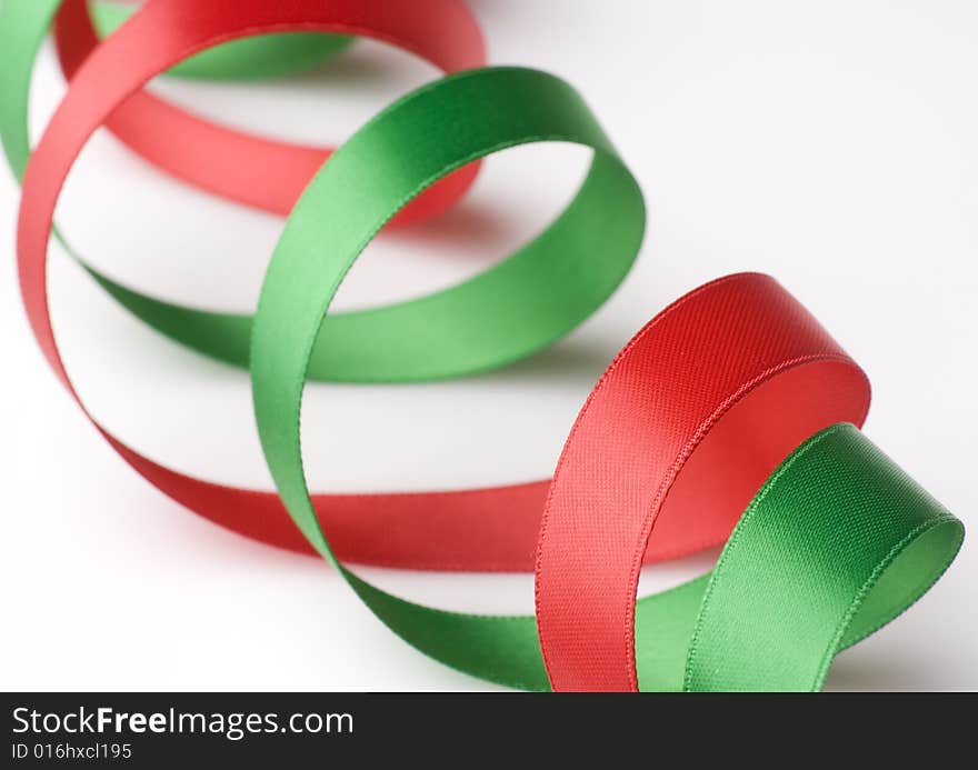 Red and green ribbon curling on white background. Red and green ribbon curling on white background