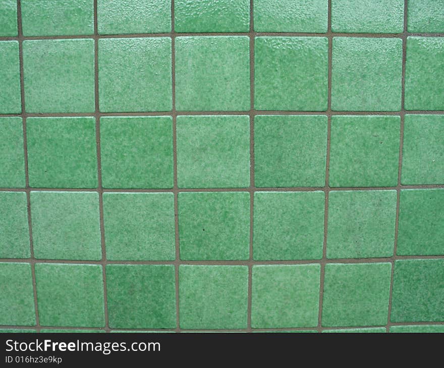 Green tiled background with grey grout