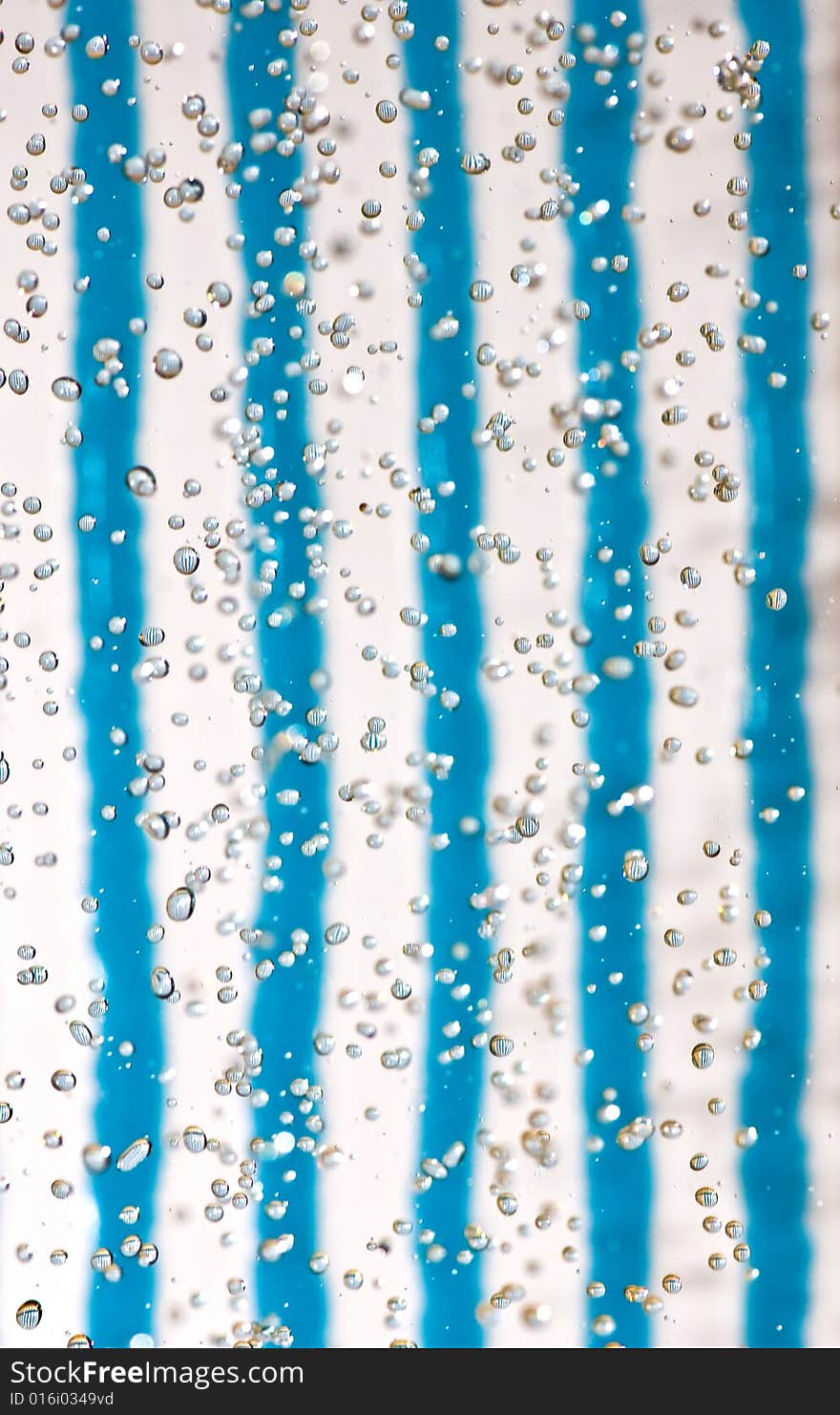 Flying drops of water on the bright coloured background