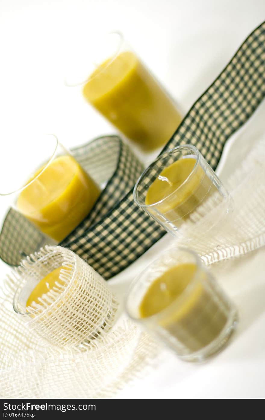 Five yellow candles and green ribbon