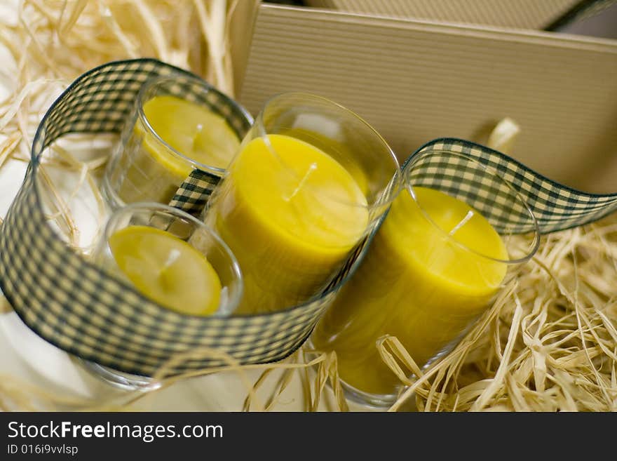 Five yellow candles, ribbon and box