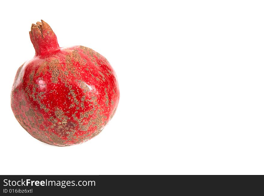 One pomegranate isolated on a white background. One pomegranate isolated on a white background.