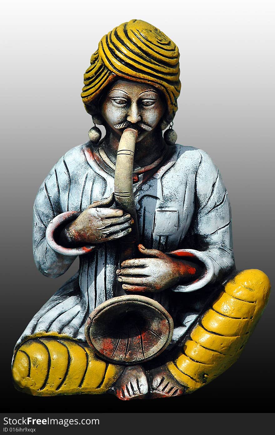 This beautiful, colorful craft is made from clay. A man playing Shahnai - an indian musical instrument. This beautiful, colorful craft is made from clay. A man playing Shahnai - an indian musical instrument.