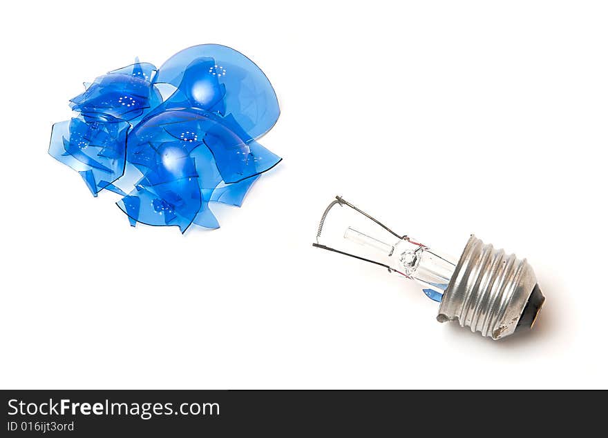 Broken blue light bulb isolated over white. Broken blue light bulb isolated over white