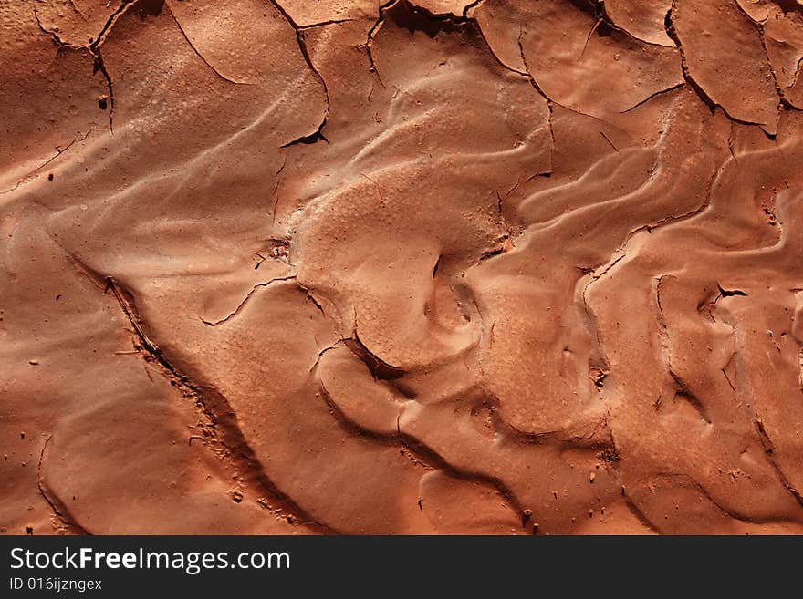 Ripples in drying reddish mud in red rock country. Ripples in drying reddish mud in red rock country